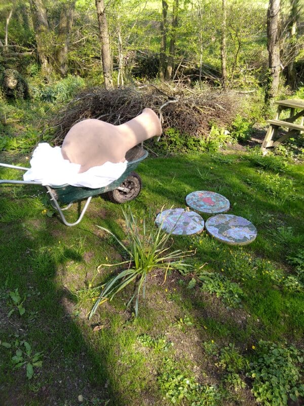 Getting into a position where we can carefully lift the chiminea out of the barrow...